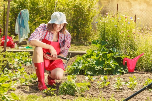 Gardening team at work with safety gear in residential garden